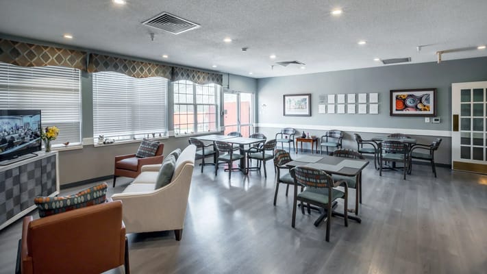 Bright common area with seating and tables