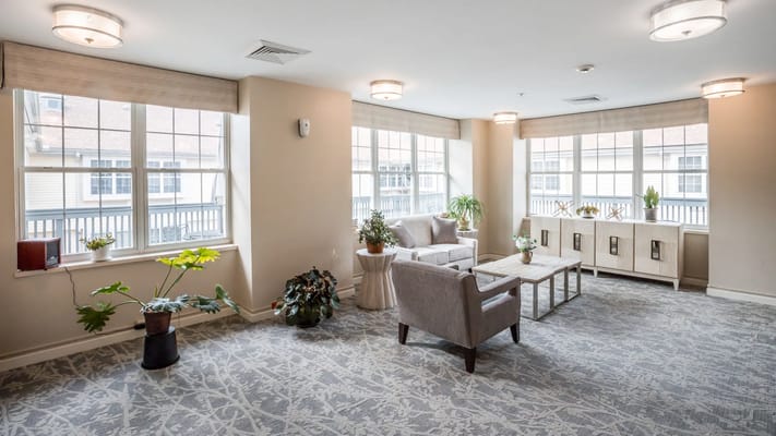 Bright common area with seating and greenery