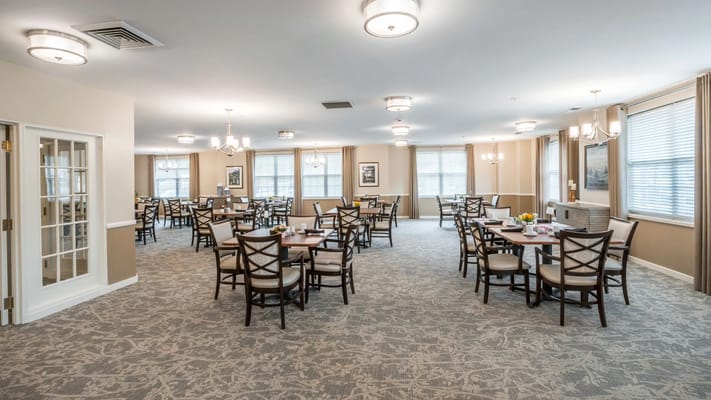Bright dining area with tables and chairs set up