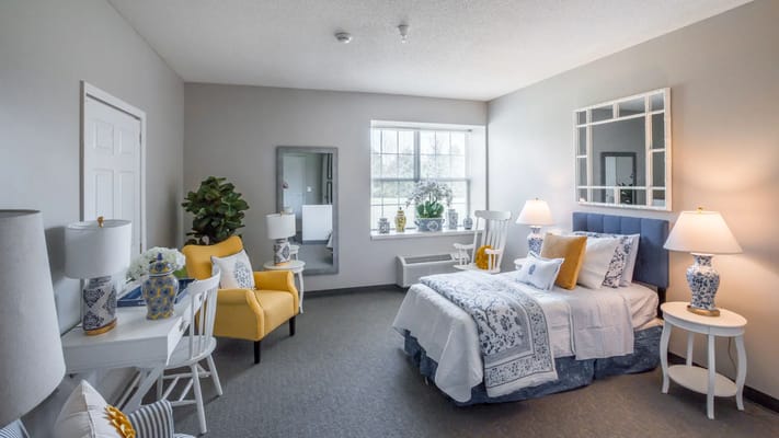 Comfortably furnished resident room with natural light