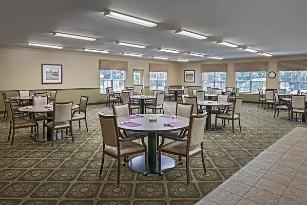 Clean dining room with tables set for meals