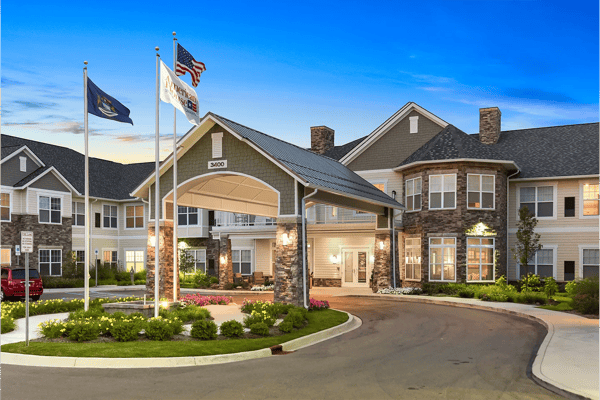 Exterior view of American House Somerset with flags and flowers