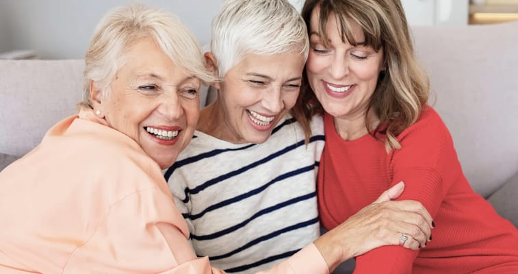 Three female residents enjoying a warm moment together