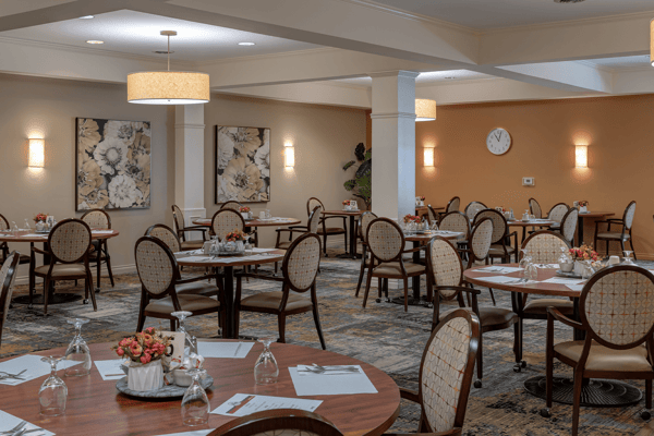 Bright dining room with tables set for meals