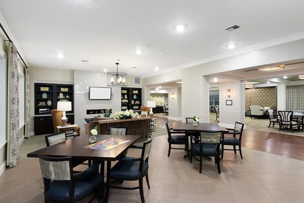 Common area of a nursing home facility with tables and seating