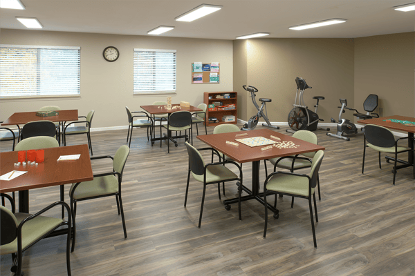 Activity room with tables and exercise equipment
