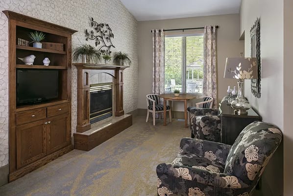 Cozy living area of a senior living unit with fireplace