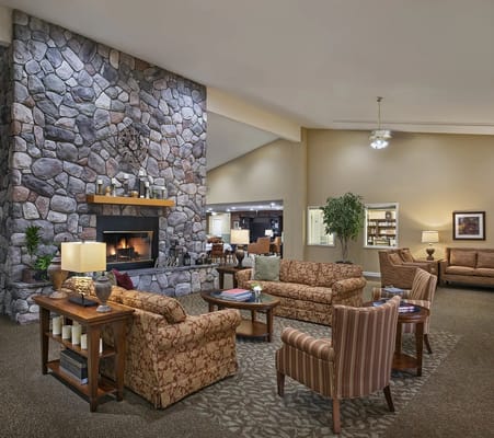 Cozy lobby area with stone fireplace and seating