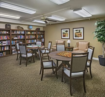 Cozy activity room with bookshelves and tables