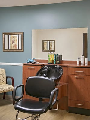 Interior of a hair salon with styling chair and products