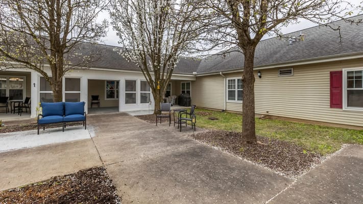 Outdoor space with seating and blooming trees
