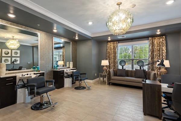 Hair salon area with styling stations and comfortable seating