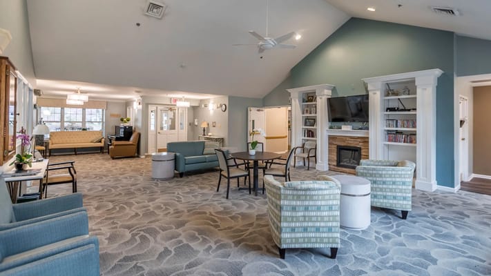 Bright common area with seating and a fireplace