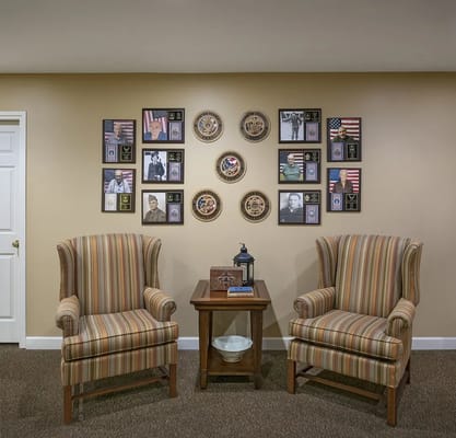 Common area with armchairs and decorated wall
