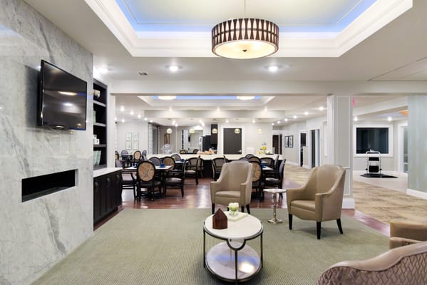 Well-lit common area with dining tables and seating