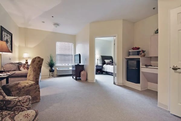 Cozy interior of a resident's room with sitting area and bedroom