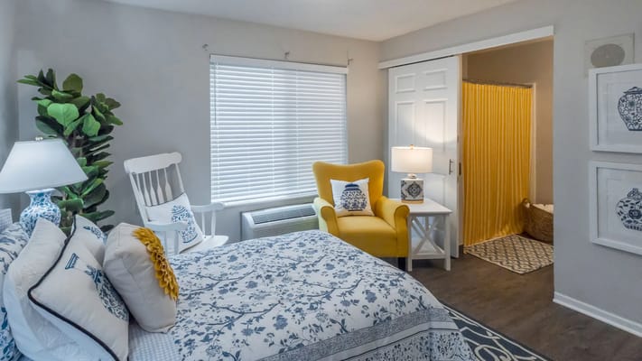 Bright and cozy resident room with yellow accents