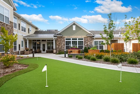 Outdoor garden area with putting green and flowers