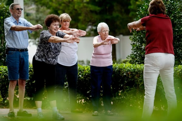 Residents participating in an outdoor exercise class