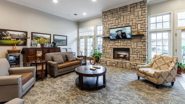 Bright common area with comfortable seating and a fireplace