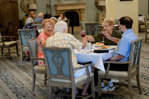 Residents enjoying dinner together in a common dining area