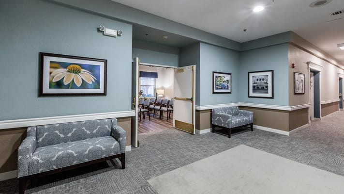 Interior hallway with seating and framed pictures