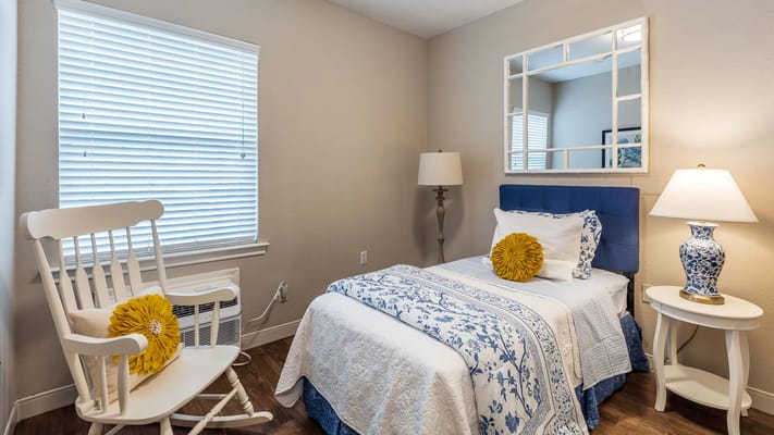 Cozy private room with bed and decorative pillow