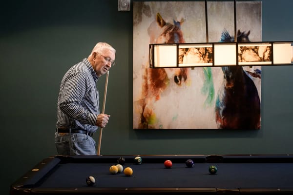 A resident playing pool in a recreational area