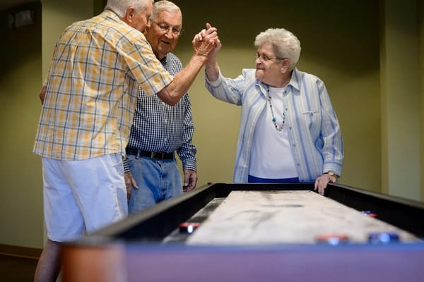 Residents enjoying a game together in a common area