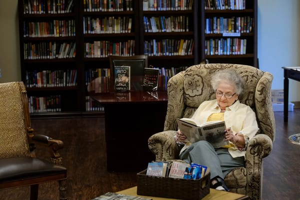 Resident reading in a cozy library area