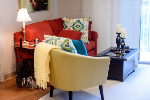 Cozy lounge area with a red sofa and decorative pillows