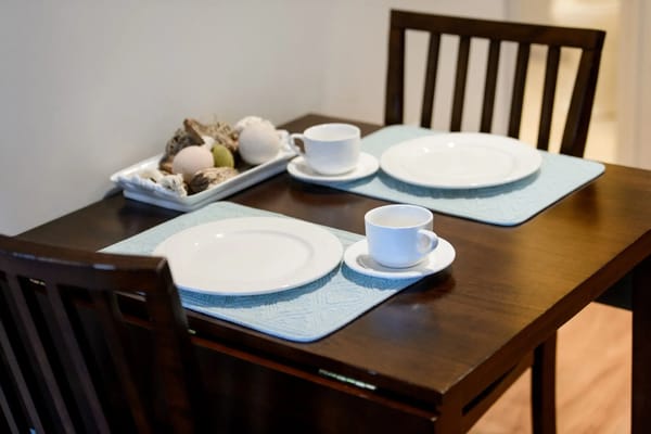 Dining table set with empty plates and cups