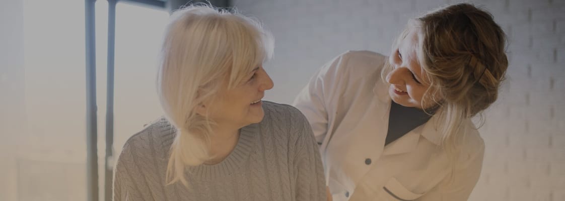 A caregiver and a resident sharing a joyful moment