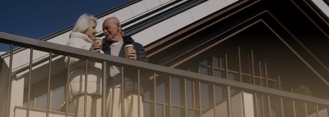Couple enjoying drinks on a balcony