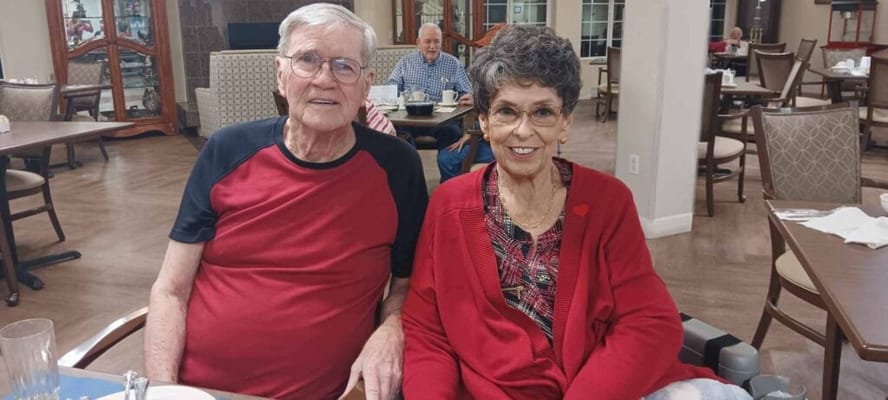 Two residents enjoying time together in the dining area
