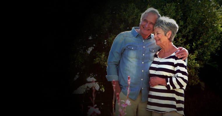 Couple smiling in a garden area