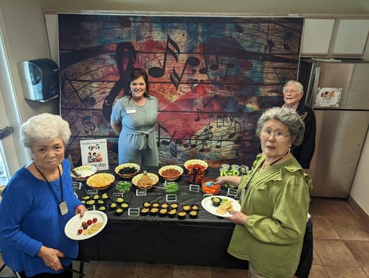 Residents enjoying a food event with a decorated table