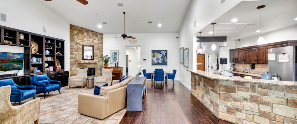 Bright common area with seating and kitchen view