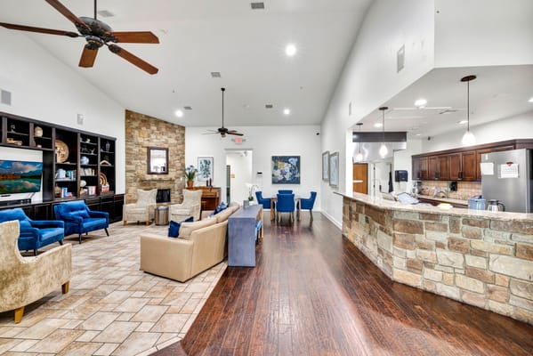 Common area with seating and kitchen in a bright room