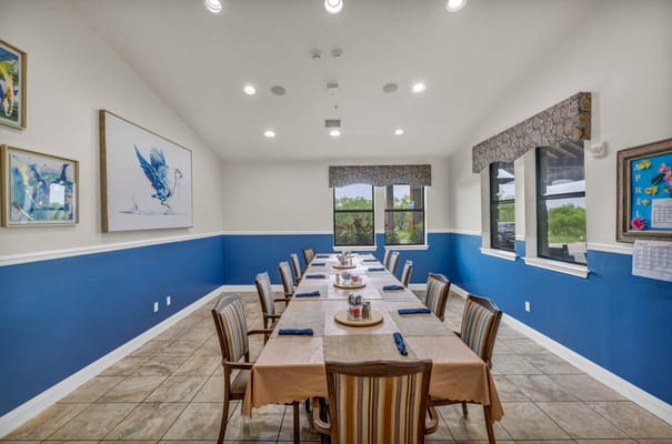 Bright dining room with a long table set for a meal