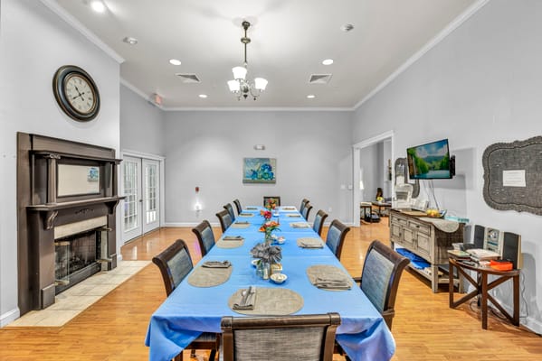 Dining area with a long table and colorful decor