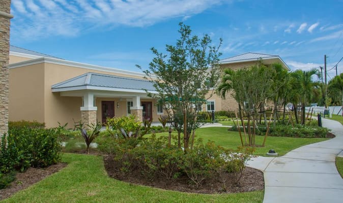 Exterior view of a senior living facility with landscaped gardens