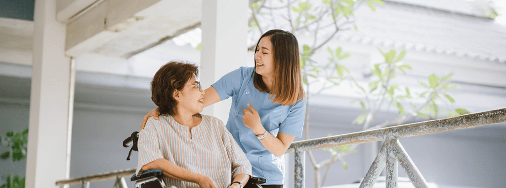 A staff member interacting with a resident outdoors