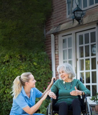 A caregiver interacting with a resident outside the facility