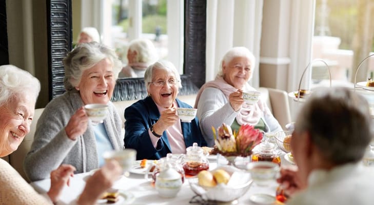 Residents enjoying tea together in a dining room