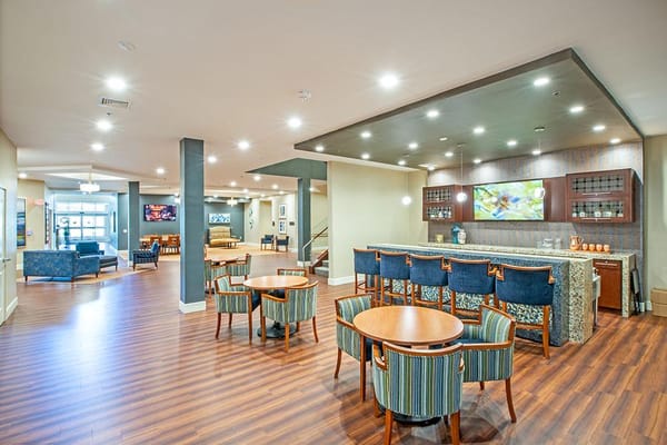 Common area with seating and bar in a senior living facility