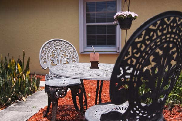 Outdoor seating area with decorative chairs and a table