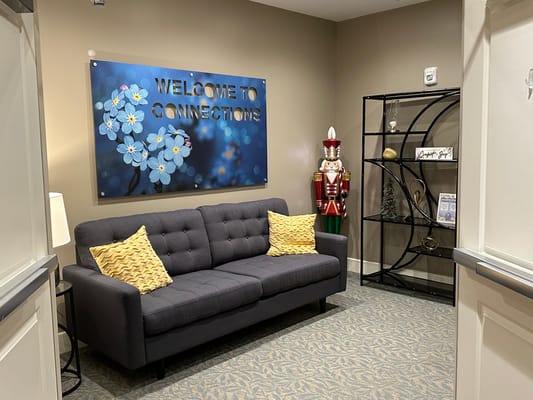 Cozy interior area with a welcome sign and seating