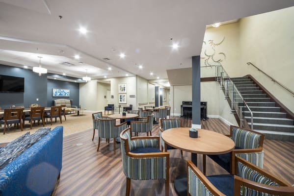 Bright common area with seating and piano