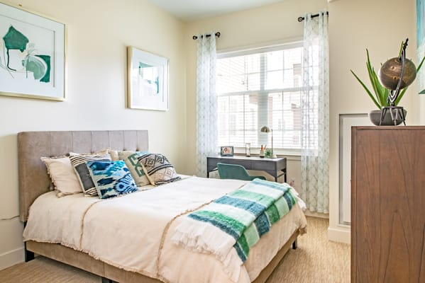 Bright private resident room with bed and desk